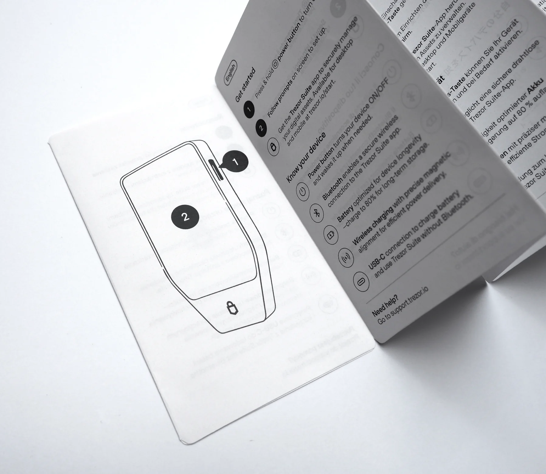 The unfolded get-started manual — numbered device diagrams and “Know your device” feature notes across several languages.