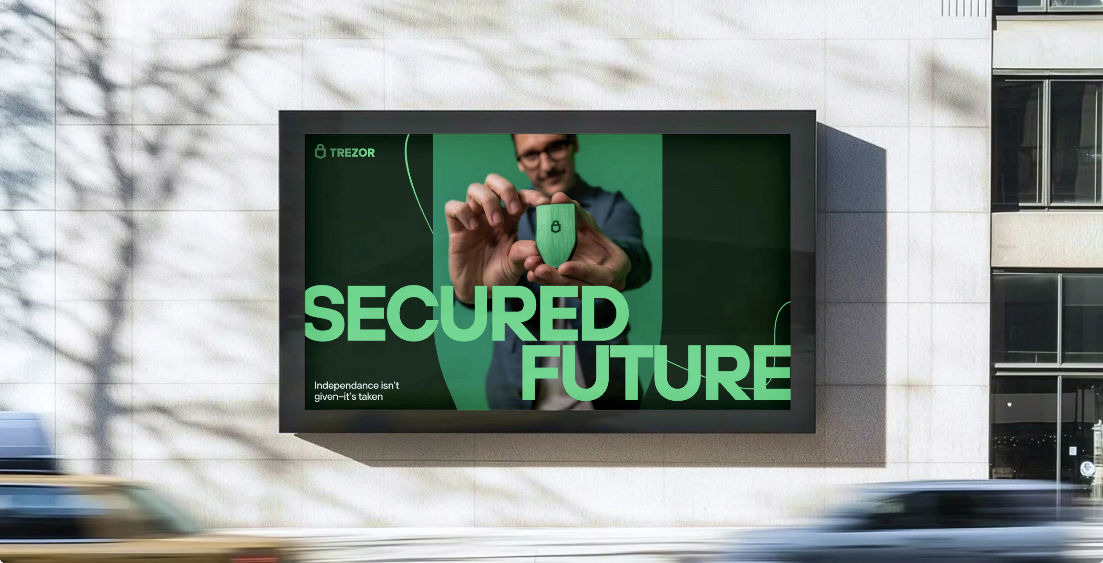 A “Secured future / Independence isn't given — it's taken” billboard on a city building.